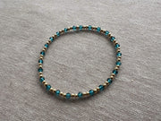 Gold Bead Bracelet with Blue Topaz accents