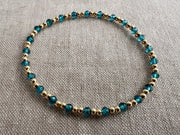 Gold Bead Bracelet with Blue Topaz accents