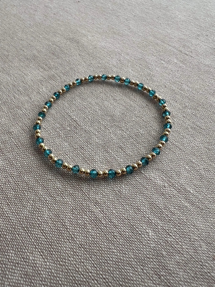Gold Bead Bracelet with Blue Topaz accents