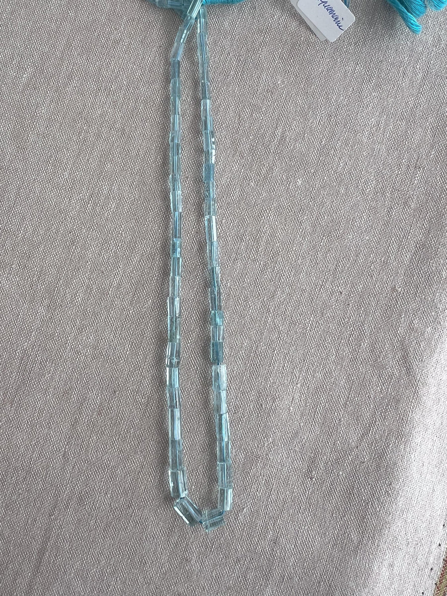 15-inch strand of AA+ Brazilian Aquamarine faceted cylinder beads, graduated from 3x5mm to 6x9mm for jewelry making.