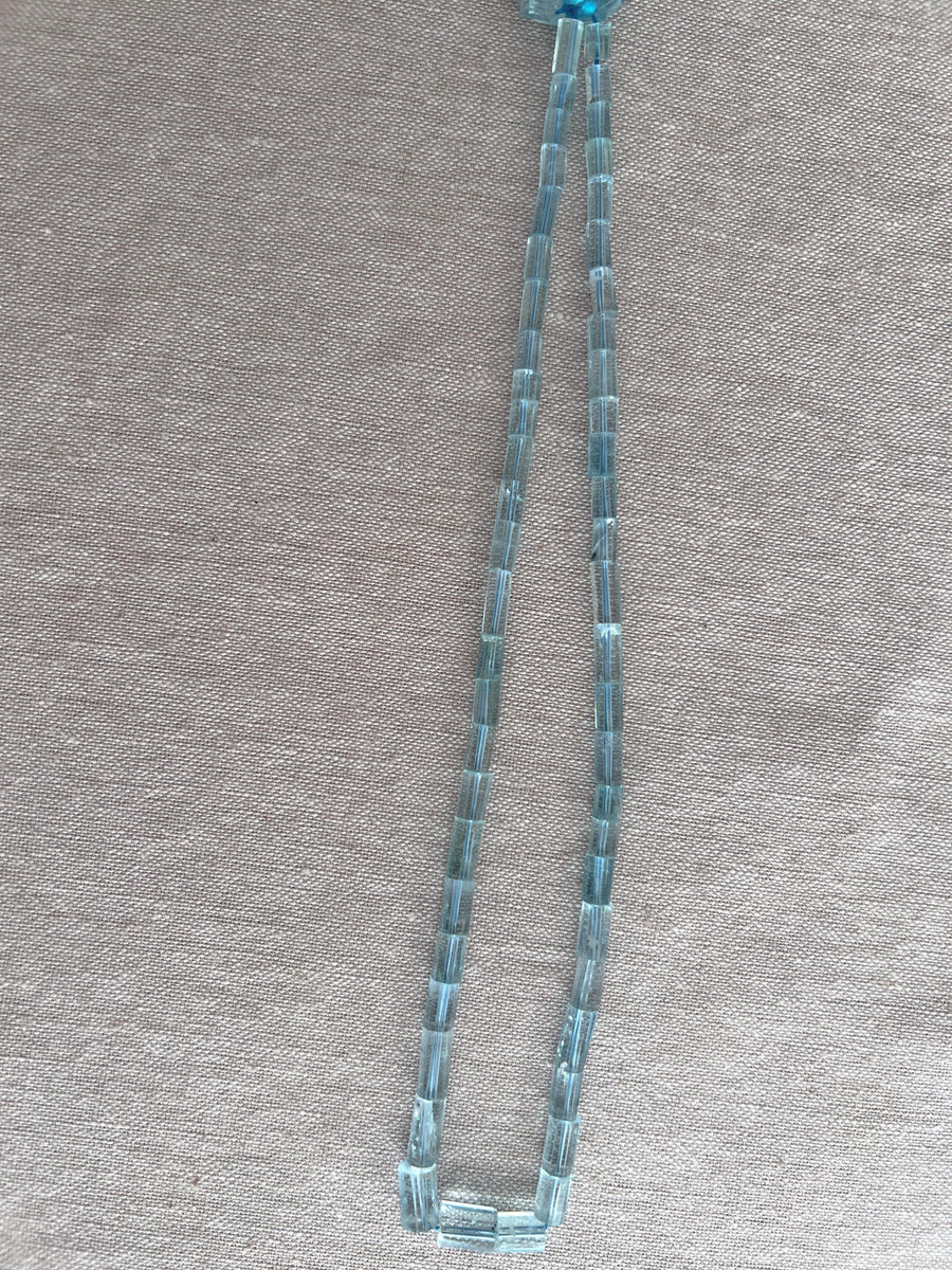 AA+ Aquamarine faceted cylinder beads in consistent light blue shades, ideal for handmade necklaces and fine gemstone jewelry.