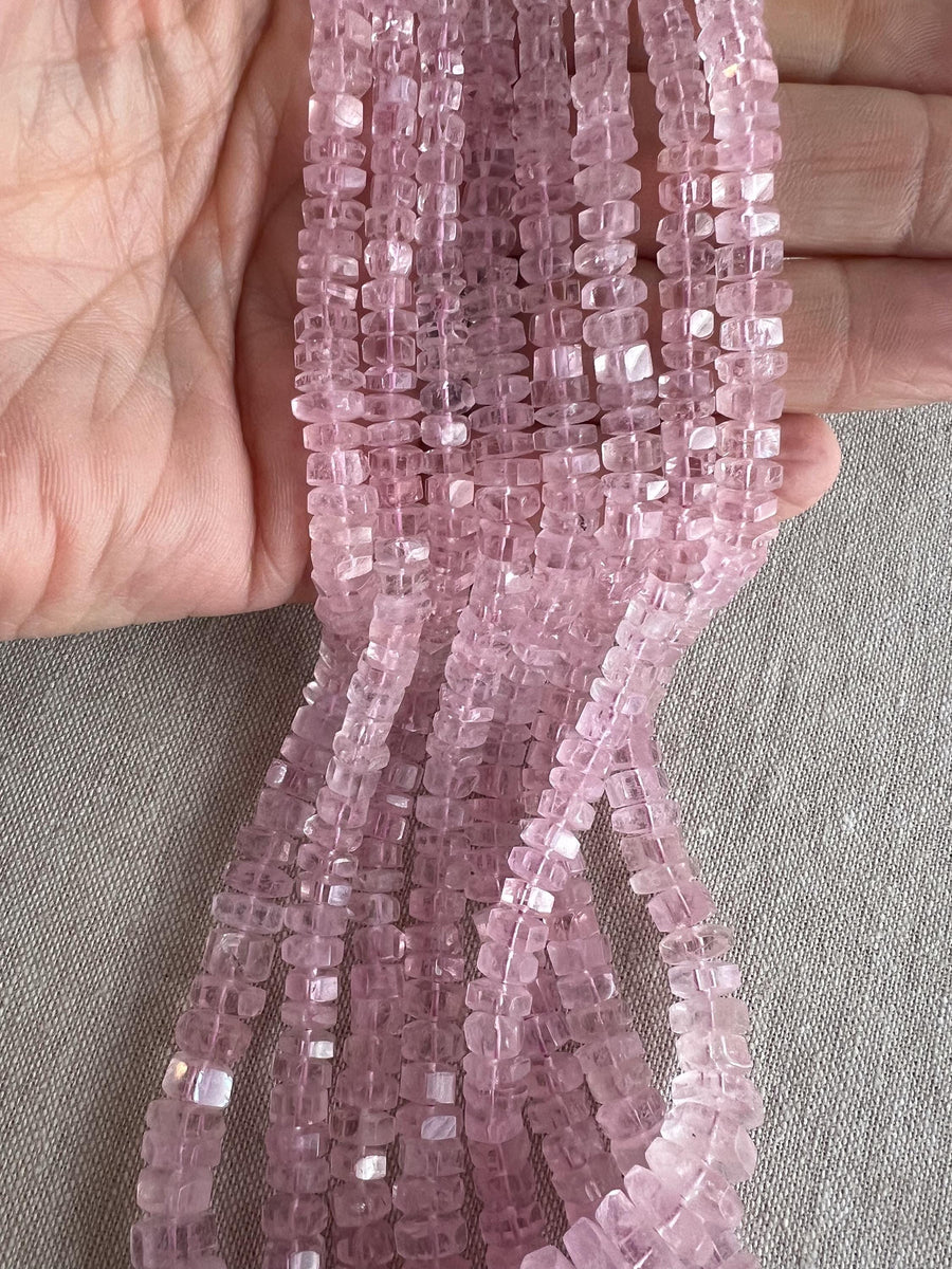 Close-up of Pink Morganite gemstone beads showing beautiful rosy pink color, transparency, and sparkling faceted bolt cuts.