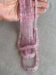 Close-up of Pink Morganite gemstone beads showing beautiful rosy pink color, transparency, and sparkling faceted bolt cuts. multiple strands