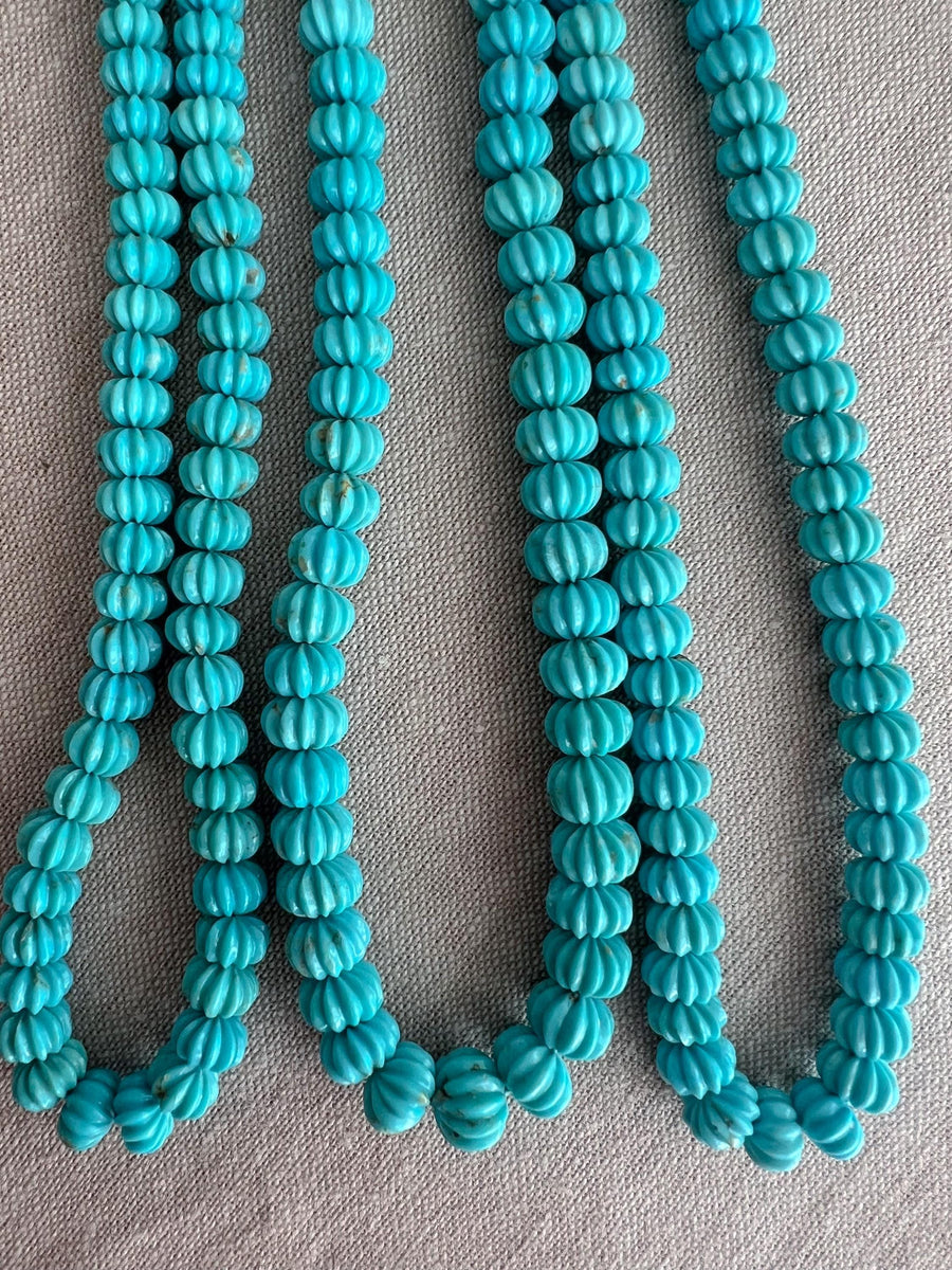 AA+ natural Sleeping Beauty Turquoise carved melon beads from Arizona, featuring classic robin's egg blue color and distinctive hand-carved grooves.
