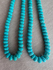 Natural untreated Sleeping Beauty Turquoise beads with distinctive carved pumpkin shapes, blue color, and contrasting brown matrix.