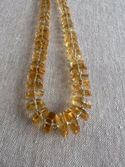 Transparent golden Citrine gemstone beads with distinctive faceted hexagonal bolt cuts, polished surfaces, and slight natural-looking color variation.