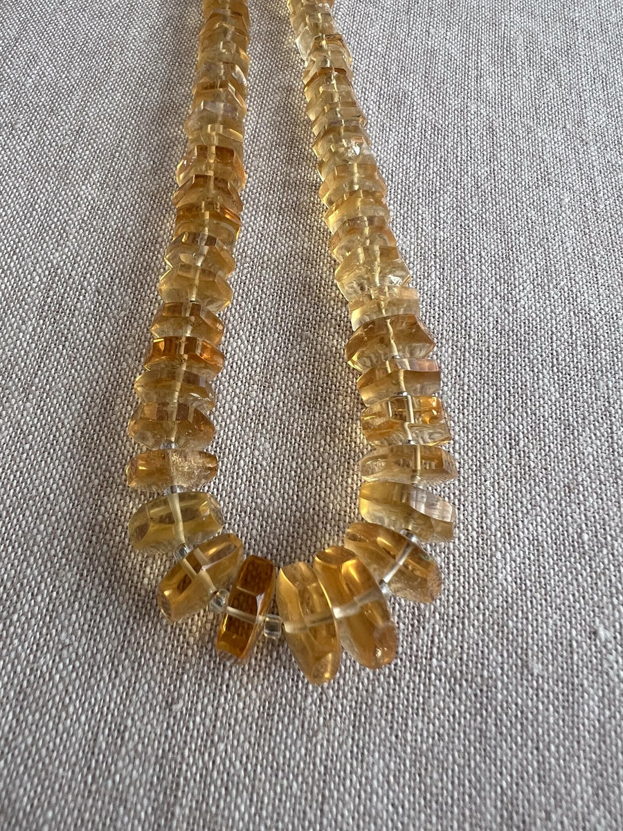 Transparent golden Citrine gemstone beads with distinctive faceted hexagonal bolt cuts, polished surfaces, and slight natural-looking color variation.