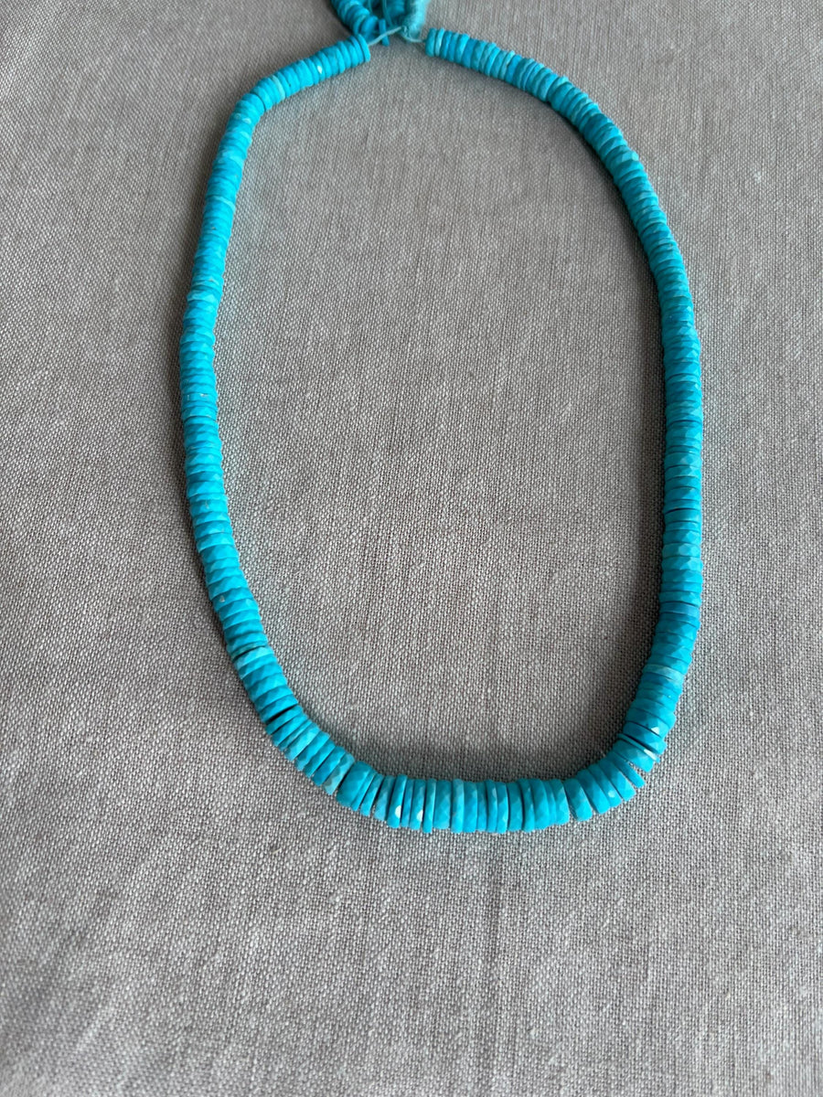 Strand of AAA Sleeping Beauty Turquoise faceted heishi gemstone beads, graduated from 5.5mm to 9mm for fine jewelry making.