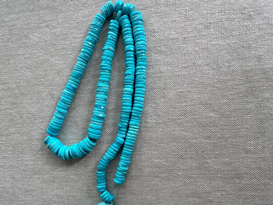 Strand of AAA Sleeping Beauty Turquoise faceted heishi gemstone beads, graduated from 5.5mm to 9mm for fine jewelry making.