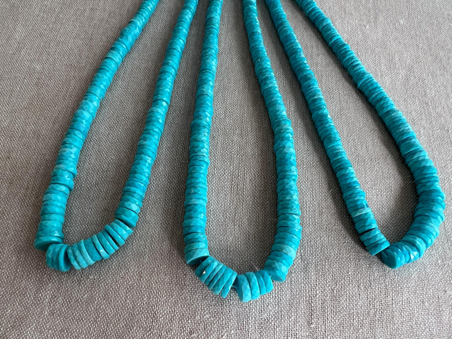 Close-up of Sleeping Beauty Turquoise heishi beads showing beautiful Arizona blue color and sparkling hand-faceted surfaces.