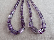 Transparent purple Amethyst gemstone beads with precision faceted cylinder cuts, beautiful clarity, and consistent violet color. two strands