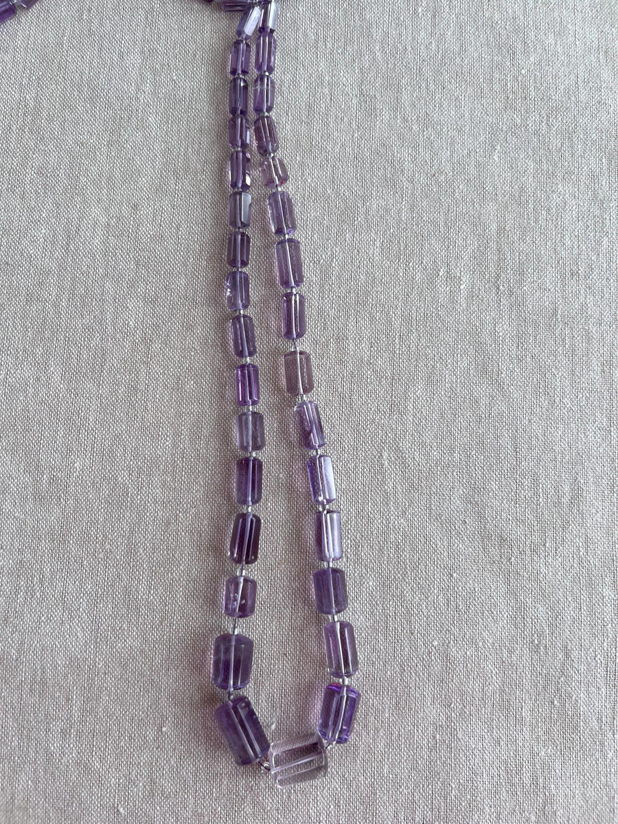 15-inch strand of AAA Brazilian Amethyst faceted cylinder gemstone beads, graduated from 5x10mm to 9x15mm.