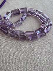 AAA Brazilian Amethyst faceted cylinder beads, transparent purple gemstones graduated from 5x10mm to 9x15mm for jewelry making.
