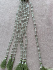 Strand of AA+ Prasiolite faceted cylinder gemstone beads from Brazil, graduated from 6x10mm to 7x12mm for jewelry making.