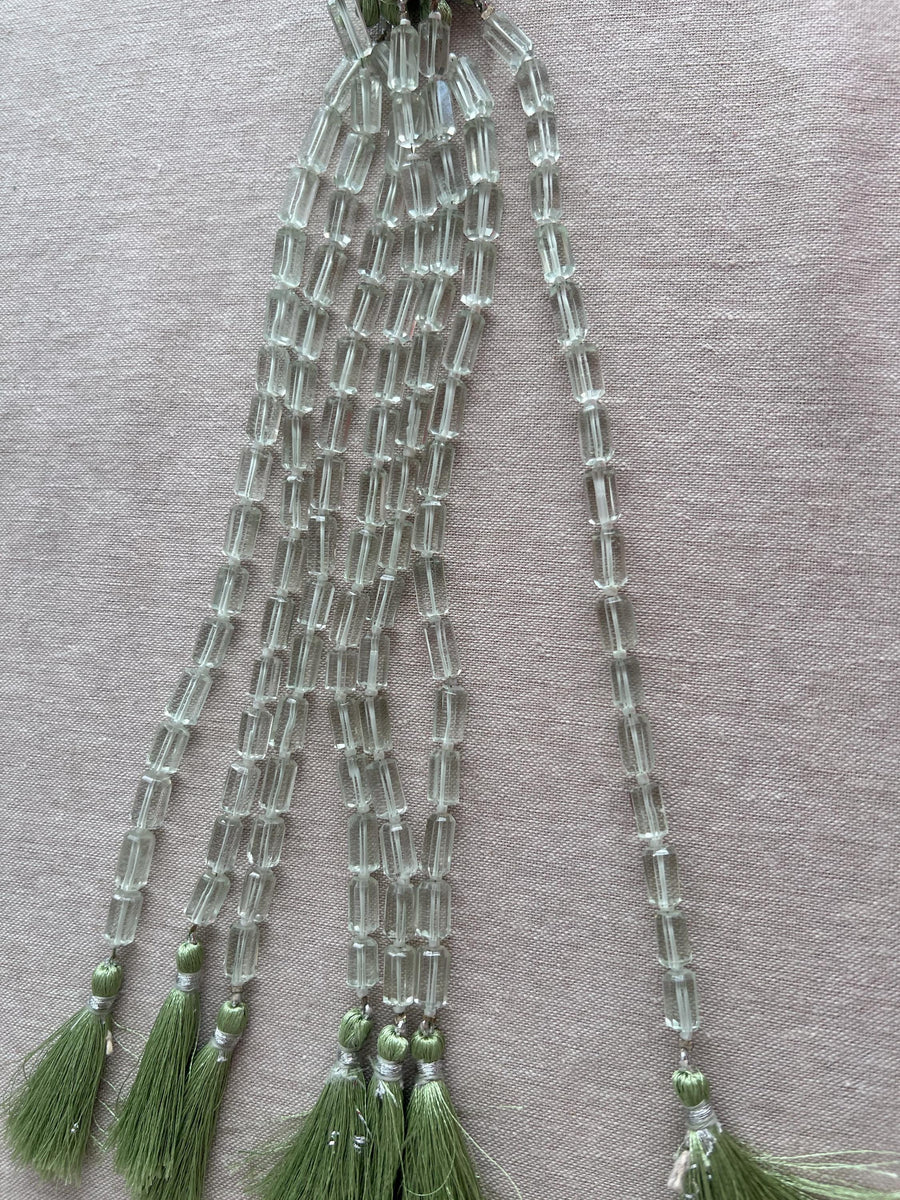 Strand of AA+ Prasiolite faceted cylinder gemstone beads from Brazil, graduated from 6x10mm to 7x12mm for jewelry making.