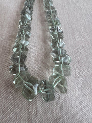 AAA green amethyst Prasiolite beads featuring unusual twisted rondelle shapes, transparent clarity, and consistent green color.