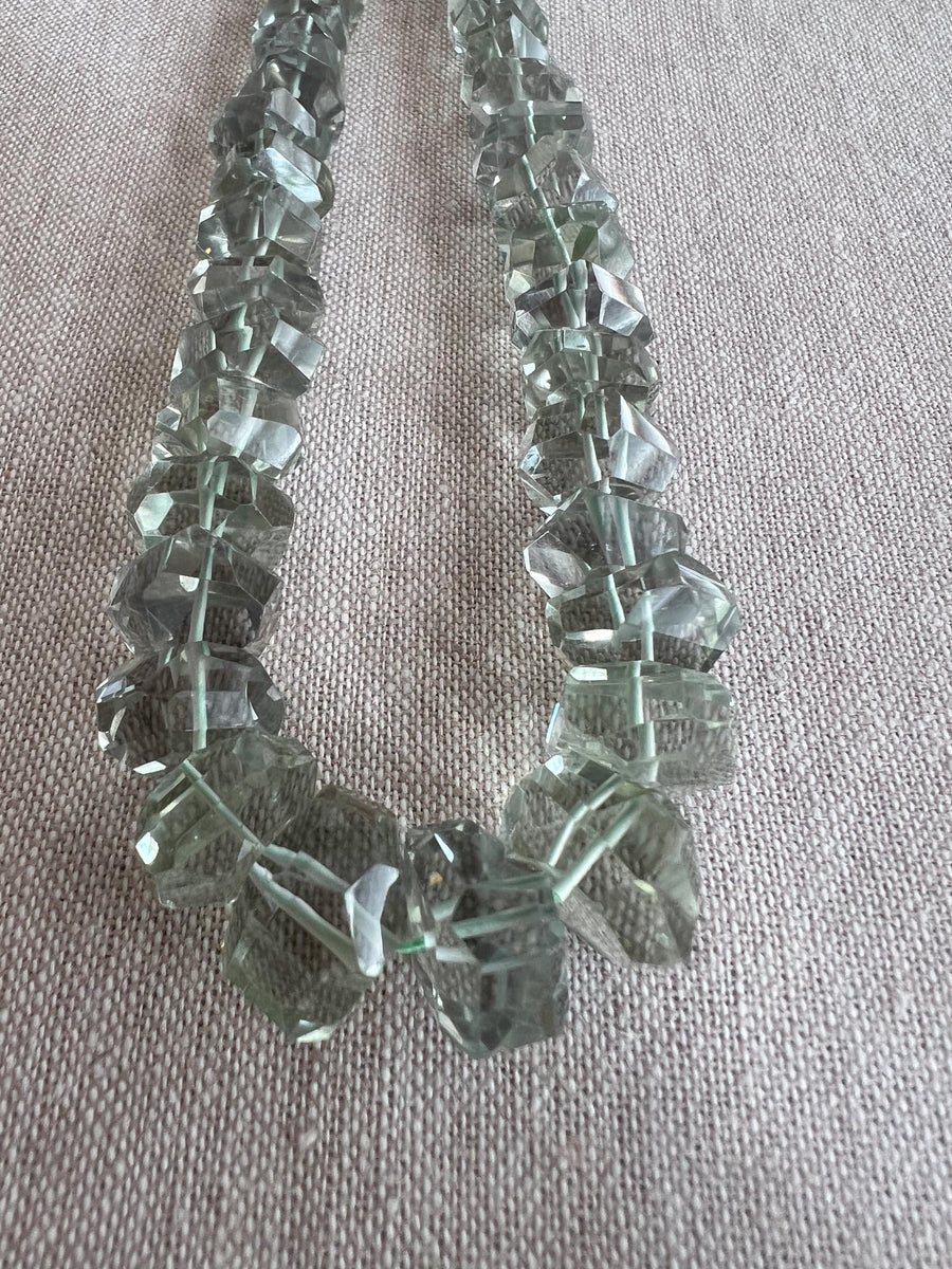 AAA green amethyst Prasiolite beads featuring unusual twisted rondelle shapes, transparent clarity, and consistent green color.