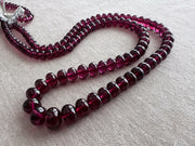 AAA+ natural Rhodolite Garnet smooth rondelle beads in rich pinkish-purple and plum shades, graduated from 6.5mm to 11mm.