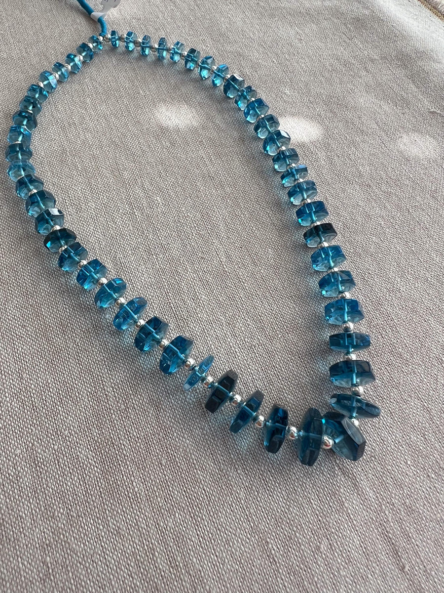 14-inch strand of Swiss Blue Topaz faceted bolt beads, 50 graduated gemstones weighing approximately 206 carats.