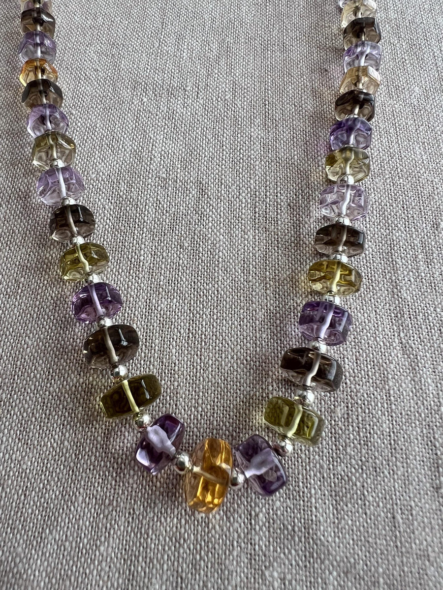 Transparent Amethyst, green Prasiolite, Citrine, and Lemon Quartz beads with sparkling faceted button cuts and excellent clarity.