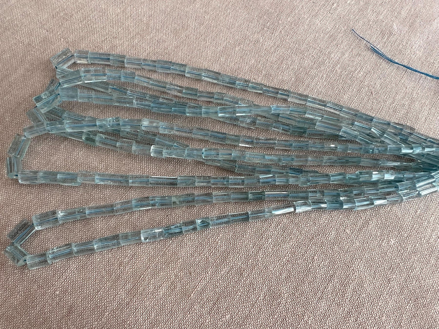 AA+ natural Brazilian Aquamarine faceted cylinder beads, transparent pale blue gemstones graduated from 3x5mm to 6x9mm. multiple strands