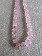 Brazilian Pink Morganite faceted cylinder and bolt-shaped beads featuring rich pink tones, translucent clarity, and polished facets.