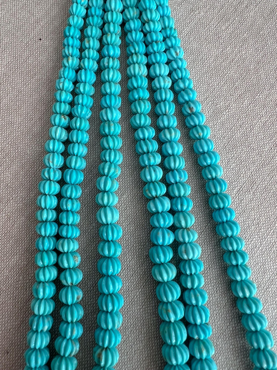 AA+ Sleeping Beauty Turquoise carved pumpkin beads with natural brown matrix and distinctive grooved surfaces for handmade gemstone jewelry.