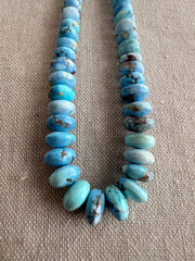 Natural untreated Golden Hills Turquoise rondelle beads featuring lavender blue gemstones with beautiful chocolate brown matrix patterns.