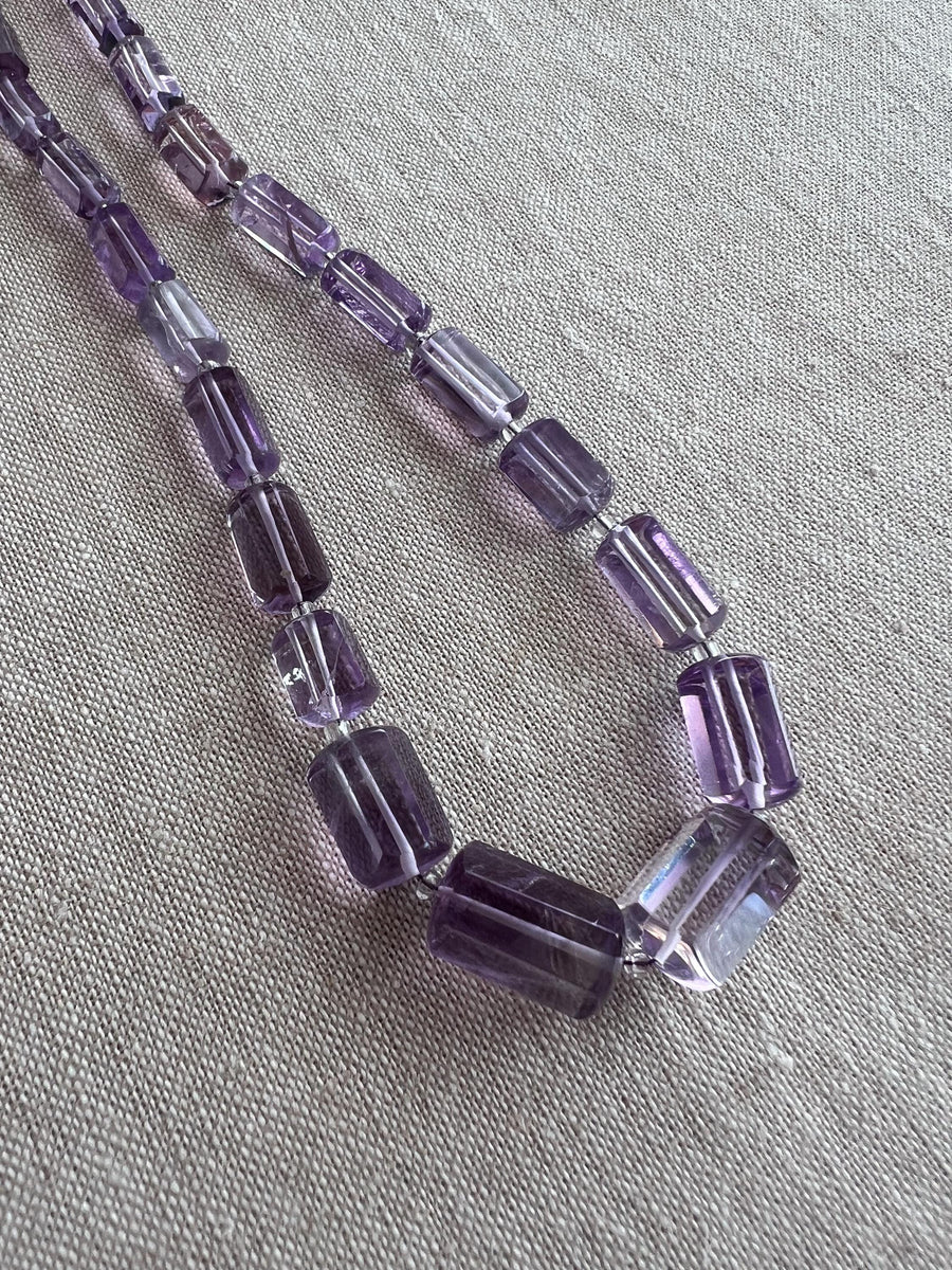 Transparent purple Amethyst gemstone beads with precision faceted cylinder cuts, beautiful clarity, and consistent violet color.