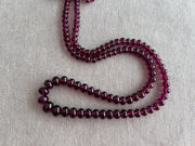 AAA+ untreated Rhodolite Garnet gemstone beads featuring transparent pinkish-purple color, eye-clean clarity, and smooth rondelle cuts.