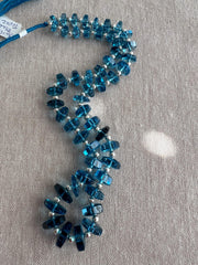 14-inch strand of Swiss Blue Topaz faceted bolt beads, 50 graduated gemstones weighing approximately 206 carats. blue gemstones