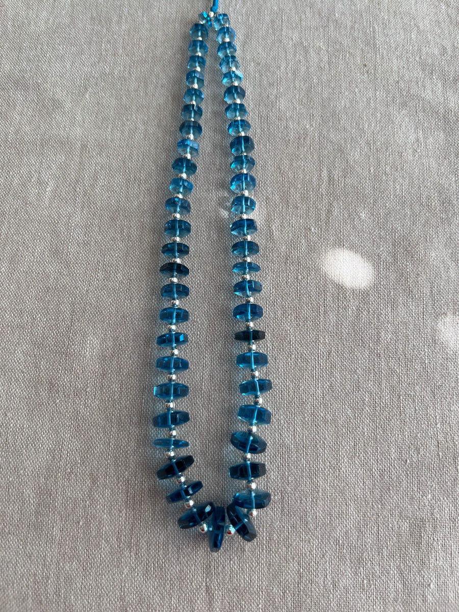 14-inch strand of Swiss Blue Topaz faceted bolt beads, 50 graduated gemstones weighing approximately 206 carats.