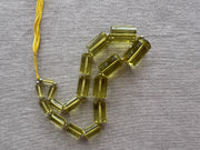 Rare 9-inch strand of 17 graduated Lemon Quartz faceted cylinder beads, ranging from 11x5mm to 20x13mm.