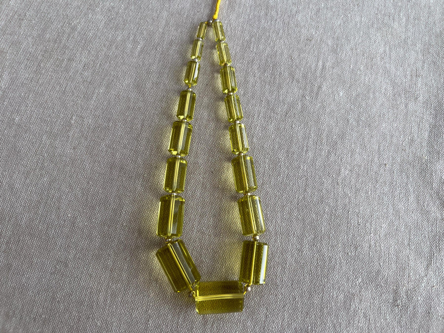 Rare 9-inch strand of 17 graduated Lemon Quartz faceted cylinder beads, ranging from 11x5mm to 20x13mm.