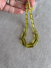 Rare 9-inch strand of 17 graduated Lemon Quartz faceted cylinder beads, ranging from 11x5mm to 20x13mm.