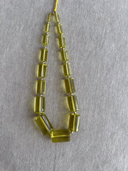Rare 9-inch strand of 17 graduated Lemon Quartz faceted cylinder beads, ranging from 11x5mm to 20x13mm.