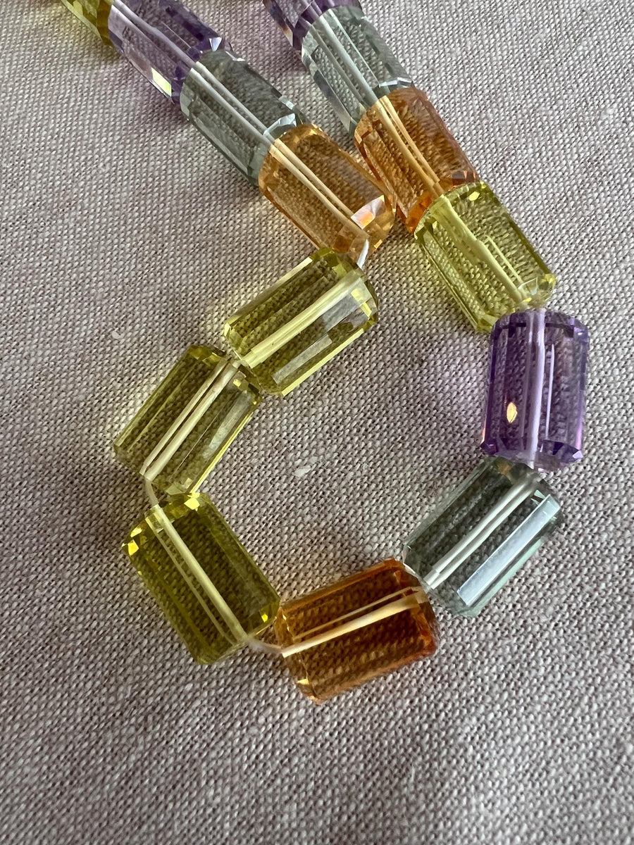 Faceted Amethyst, green Prasiolite, golden Citrine, and yellow Lemon Quartz cylinder beads in a vibrant multi-color gemstone mix.