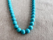 Natural Arizona Sleeping Beauty Turquoise round gemstone beads, 7mm, with exceptional blue color and clean polished surfaces.