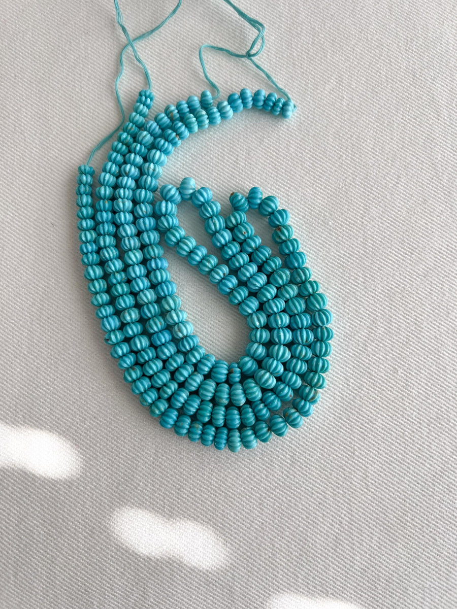 AA+ natural Sleeping Beauty Turquoise carved melon beads from Arizona, featuring classic robin's egg blue color and brown matrix.
