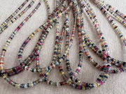 16-inch strand of natural unheated Sapphire faceted rondelle beads in assorted colors, graduated from 2.5mm to 4mm. multiple strands close up image