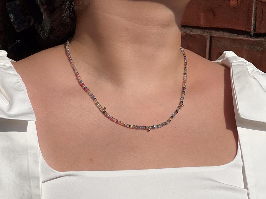 16-inch strand of natural unheated Sapphire faceted rondelle beads in assorted colors, graduated from 2.5mm to 4mm. on a model