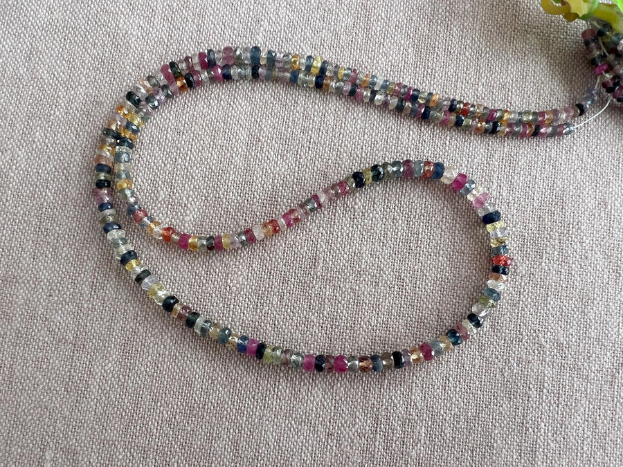 16-inch strand of natural unheated Sapphire faceted rondelle beads in assorted colors, graduated from 2.5mm to 4mm.