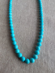 Close-up of 6mm Sleeping Beauty Turquoise round beads showing classic robin's egg blue color and smooth polished surfaces.