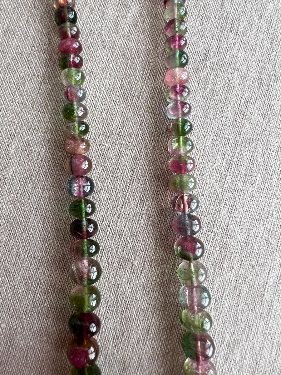 AAA-grade natural bi-color tourmaline smooth rondelle gemstone beads, graduated from 5.5mm to 11mm, featuring beautiful natural color variations for jewelry making. close up image