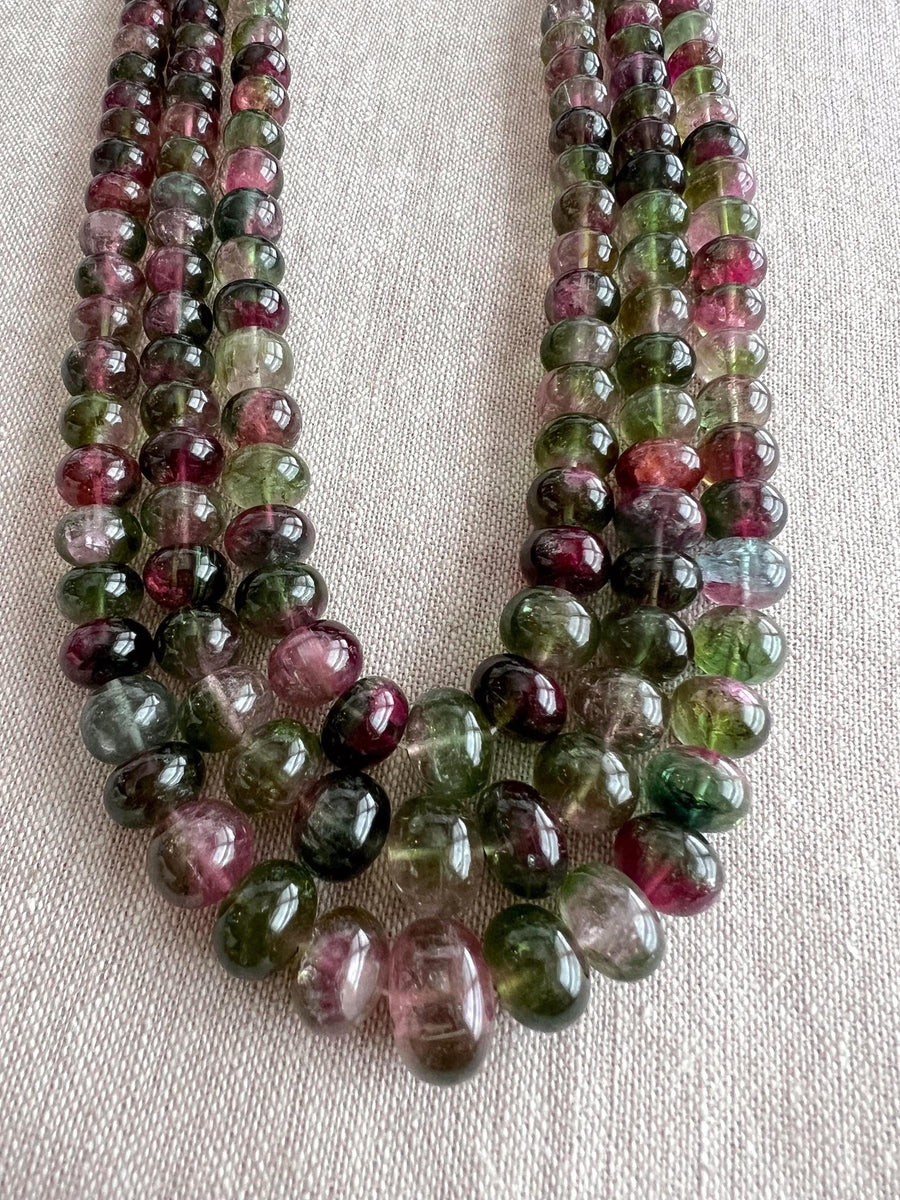 AAA-grade natural bi-color tourmaline smooth rondelle gemstone beads, graduated from 5.5mm to 11mm, featuring beautiful natural color variations for jewelry making. 3 strands close up image