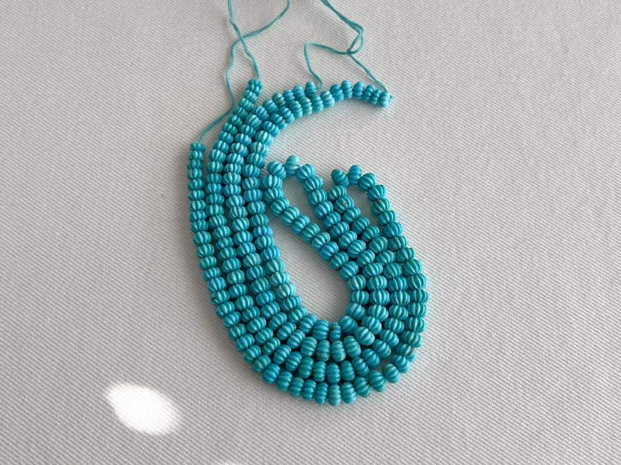 AA+ natural Sleeping Beauty Turquoise carved melon beads from Arizona, featuring classic robin's egg blue color and brown matrix.
