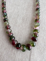 AAA-grade natural bi-color tourmaline smooth rondelle gemstone beads, graduated from 5.5mm to 11mm, featuring beautiful natural color variations for jewelry making. close up image
