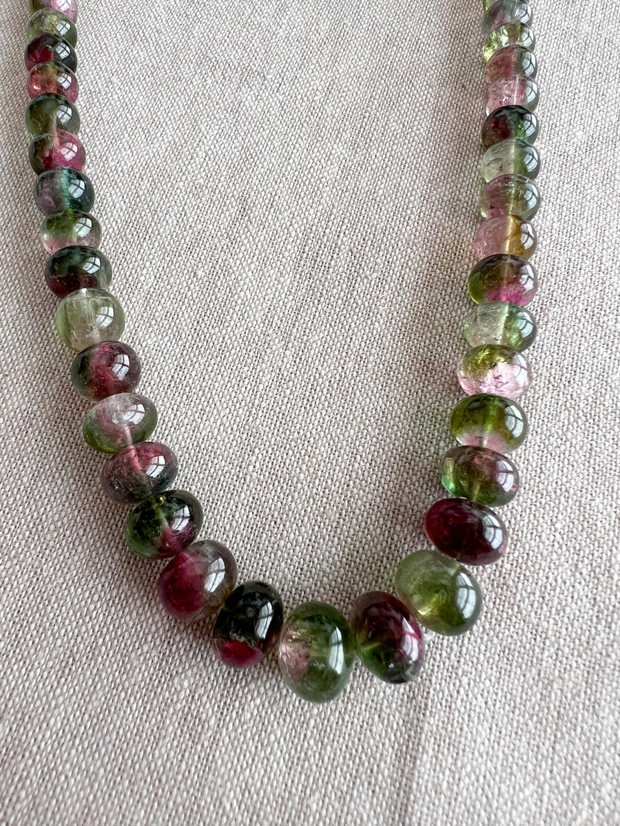 AAA-grade natural bi-color tourmaline smooth rondelle gemstone beads, graduated from 5.5mm to 11mm, featuring beautiful natural color variations for jewelry making. close up image