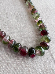 AAA-grade natural bi-color tourmaline smooth rondelle gemstone beads, graduated from 5.5mm to 11mm, featuring beautiful natural color variations for jewelry making. close detail image, green purple and pink stones