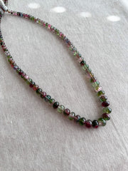 AAA-grade natural bi-color tourmaline smooth rondelle gemstone beads, graduated from 5.5mm to 11mm, featuring beautiful natural color variations for jewelry making.